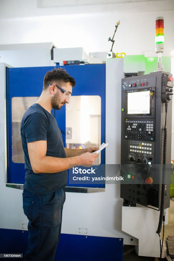 Checking Machine Drawing Young Man Checking Drawing Cnc Machine In Background Stock Photo ...