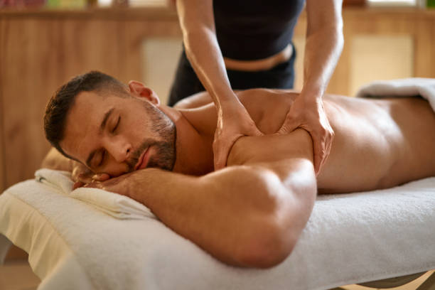 istock Young man getting relaxing massage by masseuse 1357320863