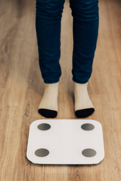 istock Girl Measures Weight on Smart Scales. Modern Electronic Device 1357321039
