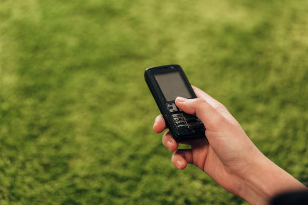 istock Girl Holds An Old Button Phone In Her Hand 1357321760