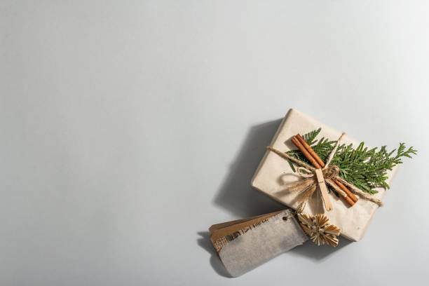 istock Zero waste gift concept. Christmas or New Year eco-friendly packaging. Festive boxes in craft paper with different organic decorations. 1357322526