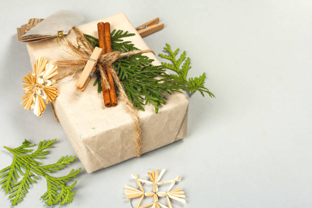 istock Zero waste gift concept. Christmas or New Year eco-friendly packaging. Festive boxes in craft paper with different organic decorations. 1357323586