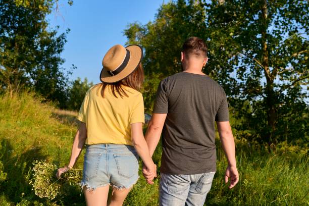 istock Happy romantic middle age couple, walking together holding hands, back view 1357323836