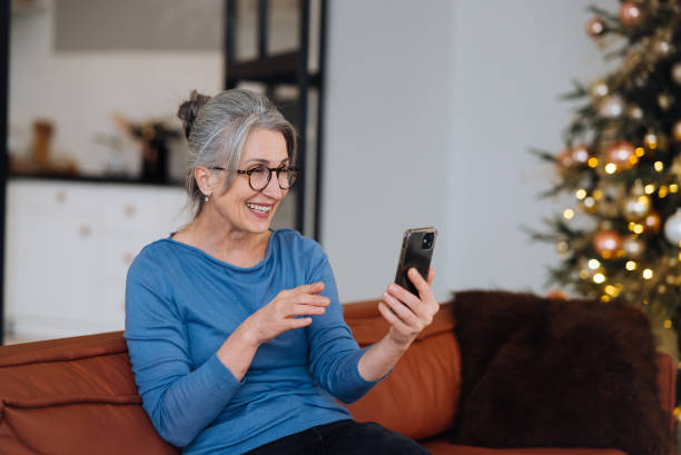 istock Happy smiley face senior elderly woman using smartphone video call 1357327002