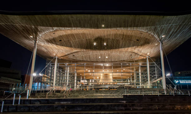 The Senedd, the Welsh National Assembly building, lights up in the evening. stock photo