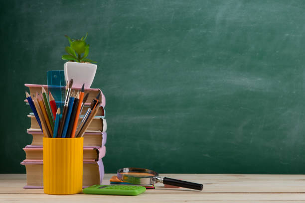 istock Education concept - books on the desk in the auditorium 1357328071