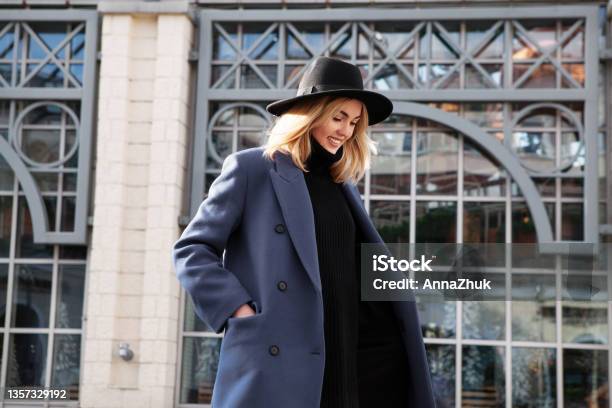 Lifestyle Portrait Of Fashionable Woman Wearing Winter Or Spring Outfit Felt Hat Gray Wool Coat And Turtleneck Outdoors Female Stylish Model Smiling Walking City Street Street Fashion Trend Stock Photo - Download Image Now