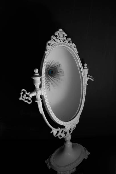 istock reflection peacock feather in vintage mirror 1357330473