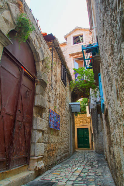 istock Scenic narrow, typical mediterranean alley in downtown Trogir 1357332005