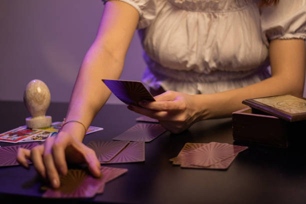 istock fortune teller woman holding tarot cards 1357335657