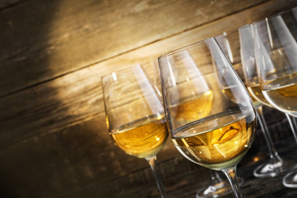 istock Refreshing White Wine in a Glasses on Wooden Background 1357335998