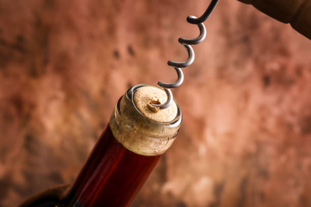 istock Corkscrew and wine bottle. Openning the bottle and degustation 1357336109