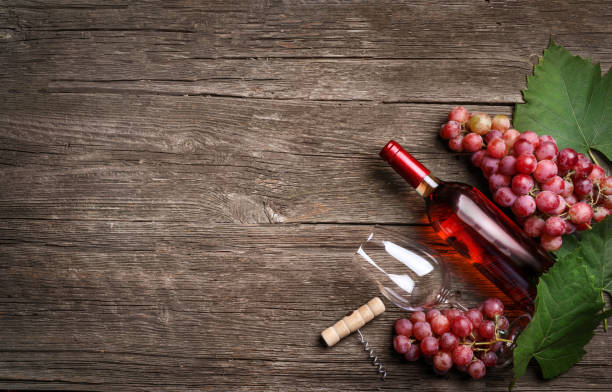 istock Grape and wine on wooden background. Top view 1357336673