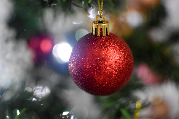 istock Christmas red bauble on a tree with bokeh lights 1357342144