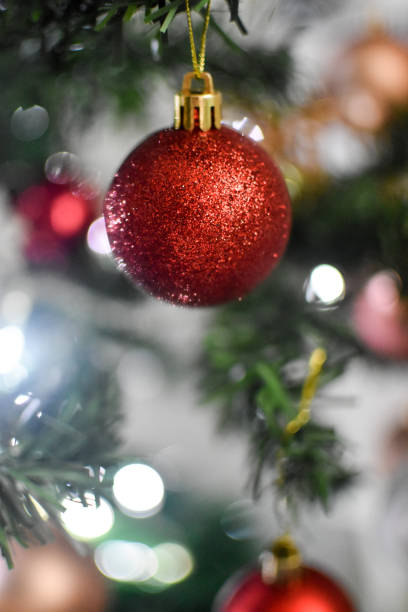istock Christmas red bauble on a tree with bokeh lights 1357342325
