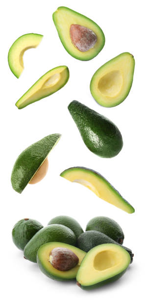istock Fresh ripe avocados falling on white background 1357342441