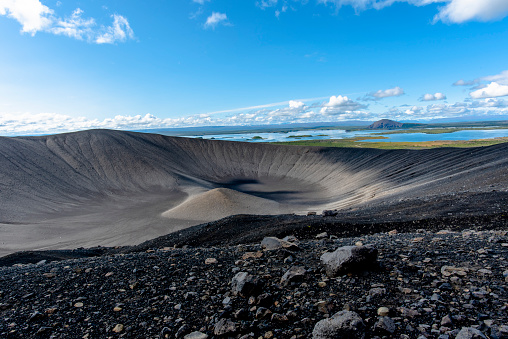 crater of Hverfjall volcano with black lava rocks in the background Lake Myvatn in the Austurland region of Iceland
