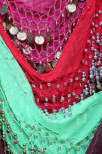 Belly dancing traditional and colorful scarves with metallic coins.