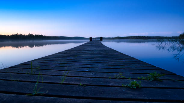 istock New paths, evening atmosphere at the lake. Light fog in the background. 1357346997