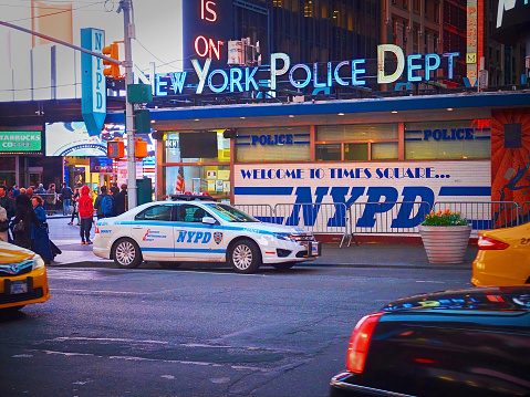 NEW YORK TIMES SQUARE, APR,24, 2015: Post of NYPD New York Police Department on Times Square among people and tourists. Police car. NYCPD NYC police. Police cops car