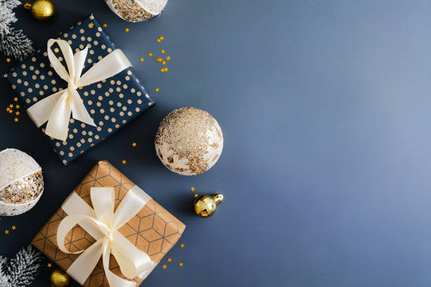 istock Vintage Christmas greeting card design with gift boxes and retro baubles on dark blue background. Flat lay, top view, copy space. 1357347312