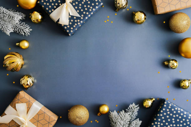 istock Christmas frame. Christmas blue background with gift boxes, golden balls, fir branches. Vintage Xmas greeting card design. 1357347315