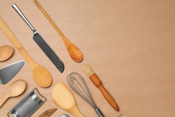 istock Set of modern cooking utensils on brown background, flat lay. Space for text 1357348066