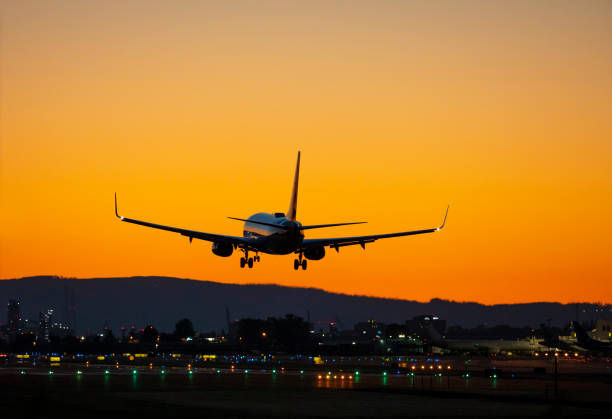 istock Airport Landing Airliner Sunset. 1357348266