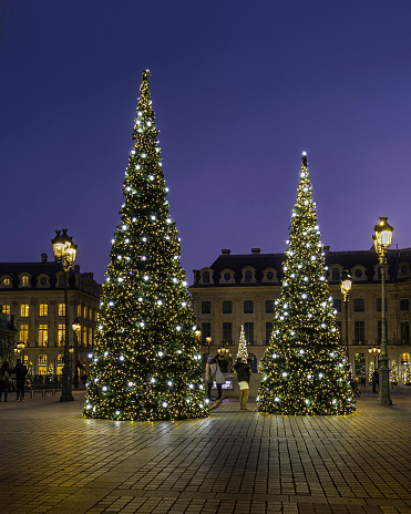 Paris, France - November 20, 2021: Christmas trees by night on Place Vendome in Paris