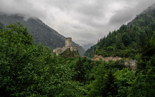 Rize, Turkey - June 12, 2021: ancient Zil fortress in the mountains of Trabzon province, Rize neighborhood in Turkey. A sample of the ancient medieval architecture of Byzantium. Romanesque castle located in a high mountain valley among wooded mountain slopes