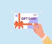 istock Human hand hold gift card, voucher or coupon. Shopping discount certificate for customers. Vector illustration 1357352749