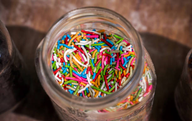 istock Top view of a glass jar with colorful chocolate chips. 1357357965