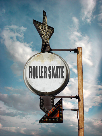 Aged and worn roller skate sign