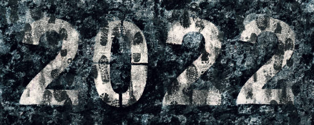 istock Numbers 2022 painted on asphalt covered with dirty footprints 1357358952