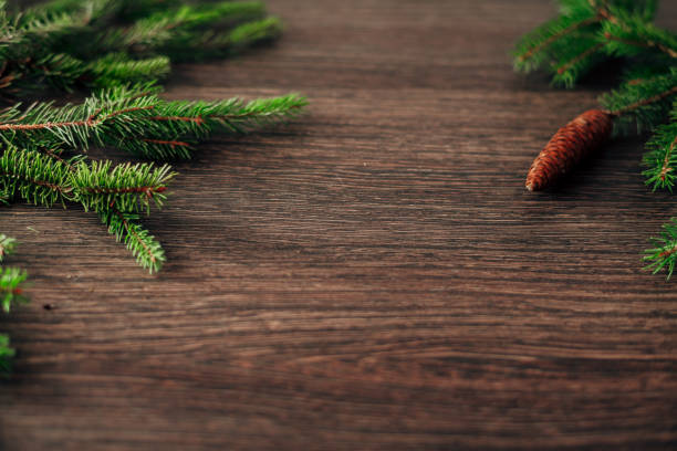 istock Decoration of Christmas Tree Branches on a Brown Background with Copy Space 1357360490