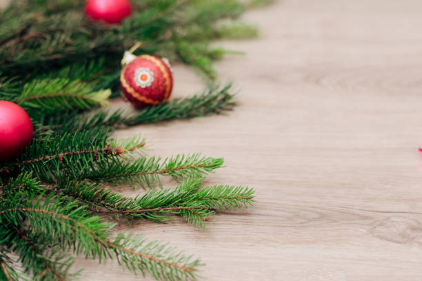 istock Christmas Tree Branches and on a Wooden Background with Copy Space 1357361472