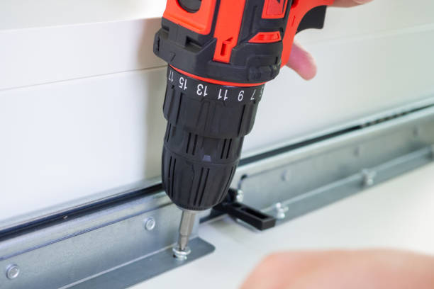 istock man assembling white table furniture at home using cordless screwdriver 1357364928