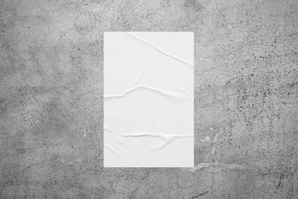 istock Blank white wheatpaste glued paper poster mockup on concrete wall background 1357364929
