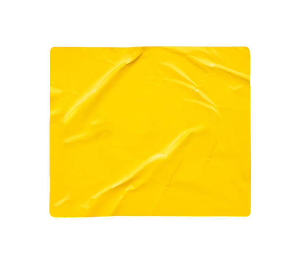 istock Blank yellow paper sticker label isolated on white background 1357364991