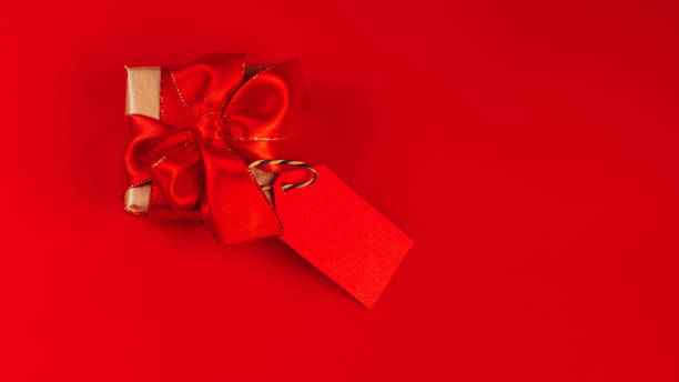 istock Gift box on a red background.Minimalism style. Creative design. Copy space. Banner.Sale, discount, shopaholism concept. Consumer society trend.Black Friday Super Sale.Black Friday shopping sale concept with red ticket Sale tag close up. 1357365129