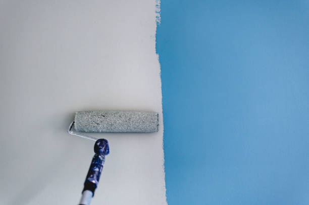 Paiting the wall with green paint stock photo