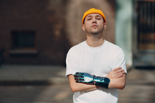 istock Young disabled man with artificial prosthetic hand in casual clothes. 1357368777