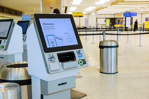 Self machine service kiosk at airport for check in printing boarding pass and buying ticket