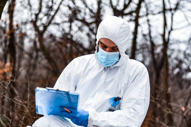 istock Forensic scientist on a crime scene collecting evidence 1357370379