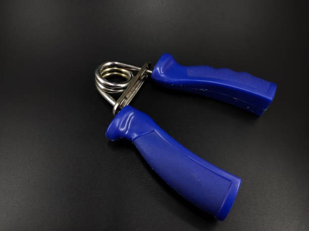 istock Hand grip device on black - stock photo 1357374777