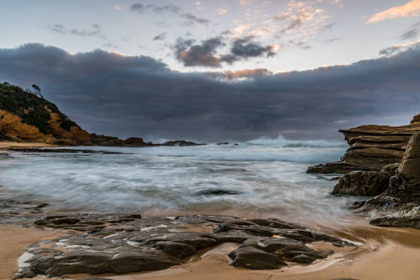 istock Rocks and splashes - seascape at Bermagui 1357374904