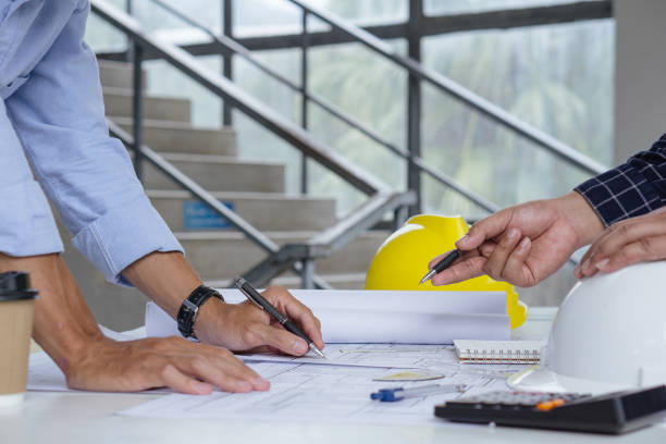 istock Architect man Design Working on Blueprint and Engineers are helping to design work on blueprints . 1357381509