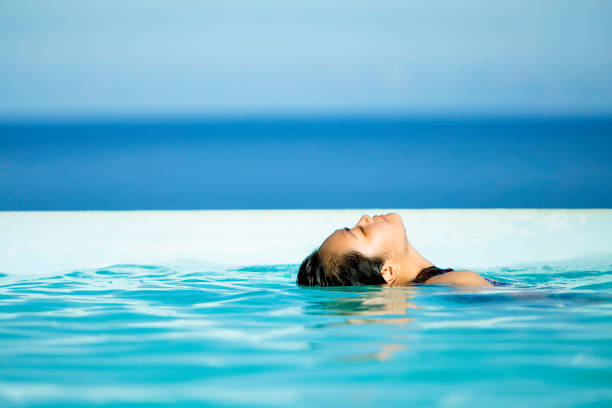 istock young asian  woman exercising in swimming pool 1357385548