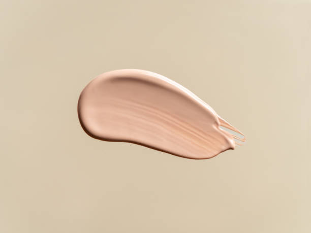 istock Liquid foundation on nude beige background 1357385756