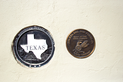 El Paso, TX: Bronze memorial plaques on the exterior of the historic Ysleta Mission on the Ysleta del Sur Pueblo, which is in the municipality of El Paso, TX.